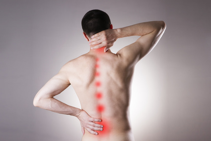 Pain in a body of the man on gray background. Red dot